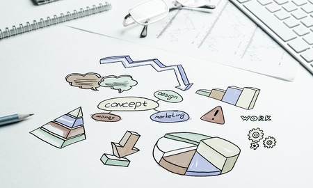 Business workplace with keyboard and marketing sketchesの写真素材