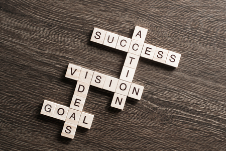 Success and other related words in crossword on wooden tableの写真素材