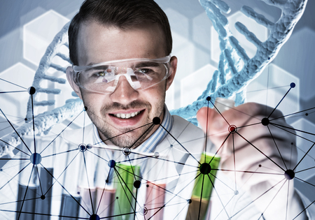 Handsome scientist making research over dna molecule structureの写真素材