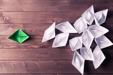 Set of origami boats on wooden tableの写真素材