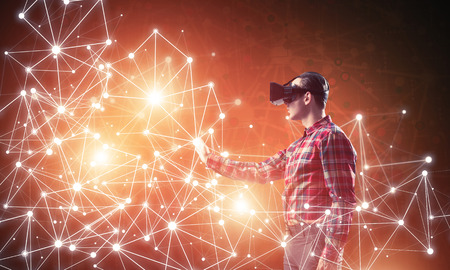 Young man with virtual reality headset or 3d glasses among connection lines
