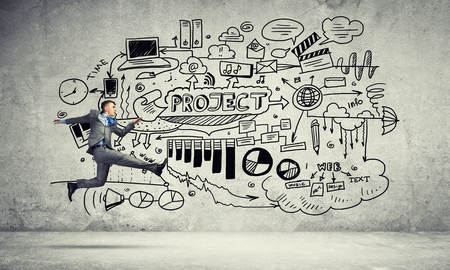 Running businessman on background of business plan sketchesの写真素材