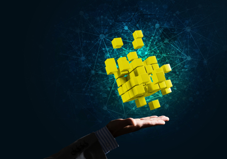 Close of businessman hand holding cube figure as symbol of innovation, mixed mediaの写真素材