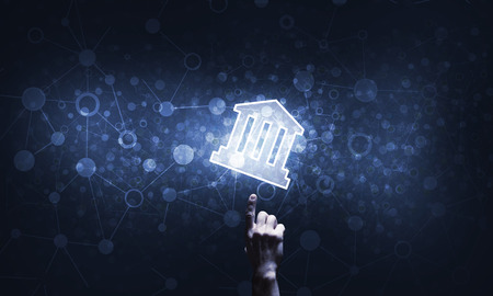 Hand of businessman touching with finger glowing home icon or symbolの写真素材