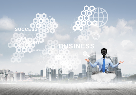 Elegant businessman outdoors floating on cloud and camera instead of headの写真素材