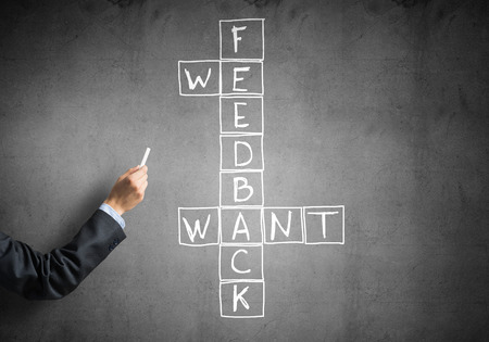 Business concept with crossword drawn with chalk on blackboardの写真素材