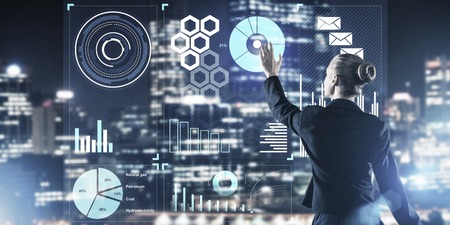 Back view of businesswoman working with virtual panel and night city at background