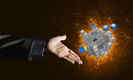 Close of businessman hand holding cube figure as symbol of innovation. 3D renderingの写真素材