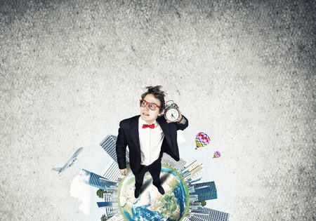 Funny disheveled businessman with alarm clock from top view. Elements of this image are furnished by NASAの写真素材