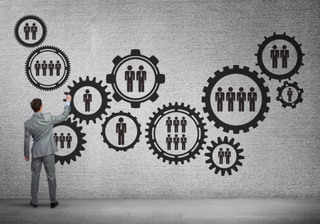 Businessman standing with back and drawing concept of teamwork and cooperationの写真素材