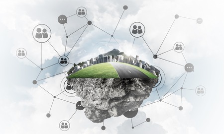 Beautiful small island with grass and cityscape levitating in the skyの写真素材