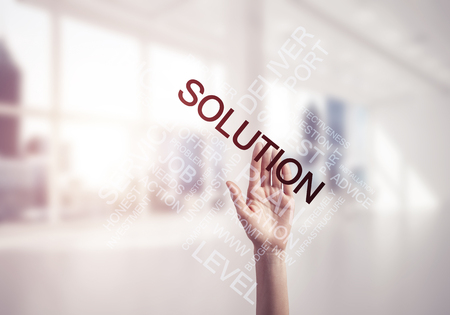 Close of businesswoman hand touching screen with business conceptual wordsの写真素材