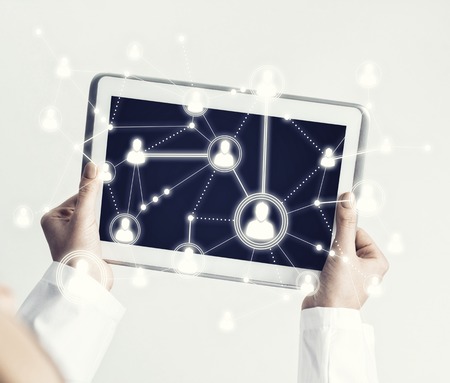 Tablet pc device with connection lines on screen in hands of doctor