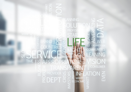 Close of businesswoman hand touching screen with business conceptual wordsの写真素材