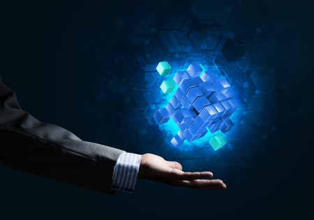 Close of businessman hand holding cube figure as symbol of innovation. 3D renderingの写真素材