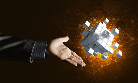Close of businessman hand holding cube figure as symbol of innovation. 3D renderingの写真素材