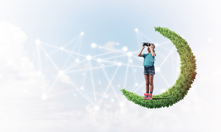 Cute kid girl on green moon and social connection conceptの写真素材