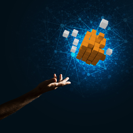 Close of man hand holding cube figure as symbol of innovation. Mixed media.の写真素材