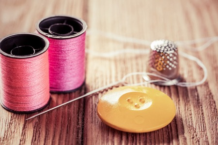 Bright image of sewing kit accessories on wooden table