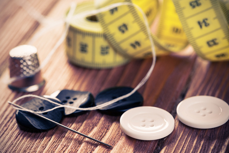 Bright image of sewing kit accessories on wooden tableの写真素材
