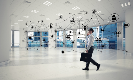 Elegant businessman in 3D office interior and social connection concept. Mixed mediaの写真素材