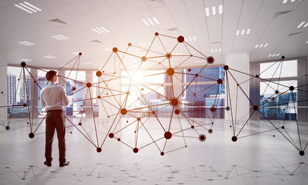 Elegant businessman in modern office interior and social connection concept. Mixed mediaの写真素材