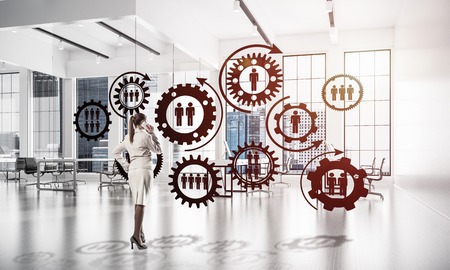 Elegant businesswoman in modern office talking mobile phone and social connection concept. Mixed mediaの写真素材