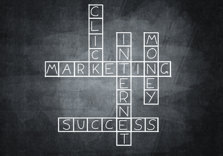 Business concept with crossword drawn on blackboardの写真素材