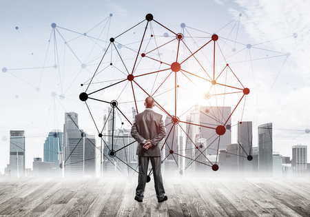 Businessman standing with back and looking at network drawn conceptの写真素材