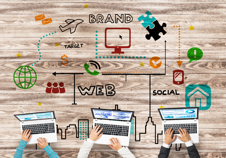 Group of three people with devices in hands working together as symbol of networking and communication Group of three people with devices in hands working together as symbol of networking and communication