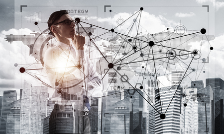 Double exposure of elegant businessman with hand on chin looking awayの写真素材
