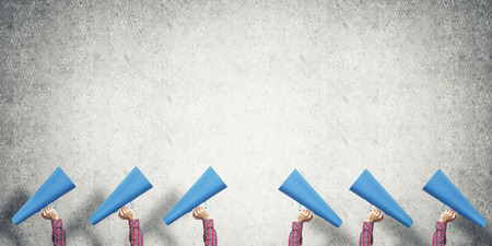 Close of woman making announcement in paper trumpetの写真素材