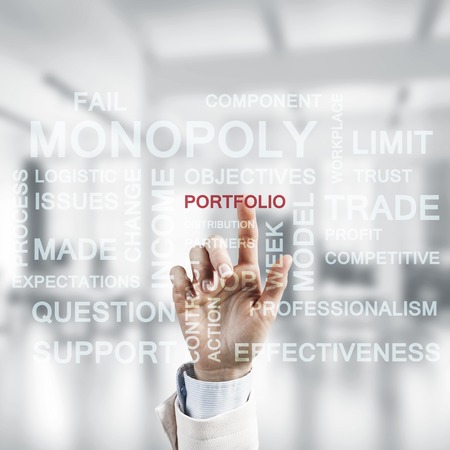 Close of businesswoman hand touching with finger screen with business conceptual wordsの写真素材
