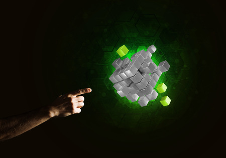 Close of man hand holding cube figure as symbol of innovation. Mixed media.の写真素材