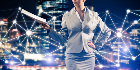 Close of businesswoman holding papers in hand and connection lines at backgroundの写真素材