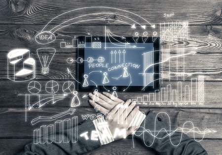 Top view of businesswoman sitting at table with tablet deviceの写真素材