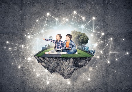 ECO concept floating island and children with book sitting on itの写真素材