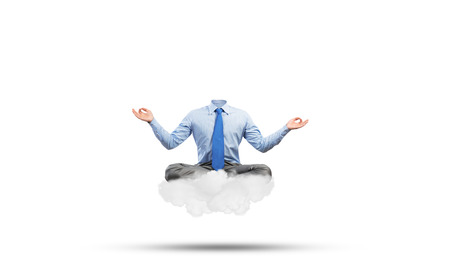 Businessman in lotus pose with lamp head meditating on cloudの写真素材