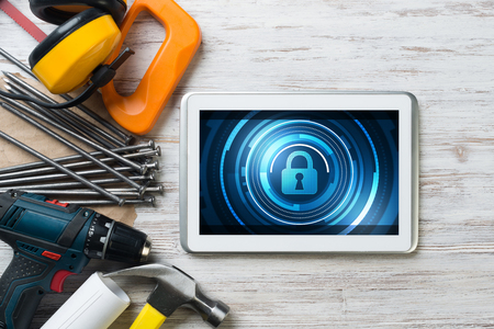 Tablet pc with security concept on screen and industrial tools aroundの写真素材