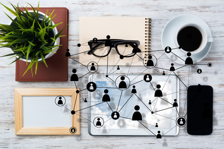 Top view of modern workplace with office stuff and social network connection above presenting still office life. Mixed media.の写真素材