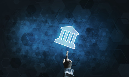 Hand of businessman touching with finger glowing home icon or symbolの写真素材