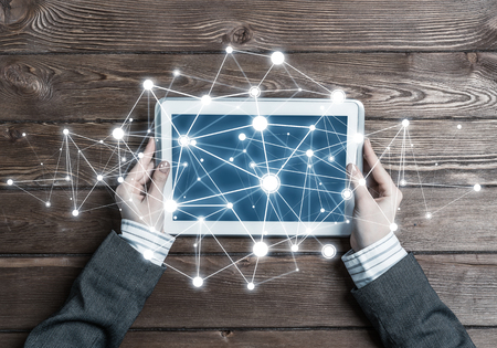 Top view of woman in business suit sitting at table and using tablet deviceの写真素材