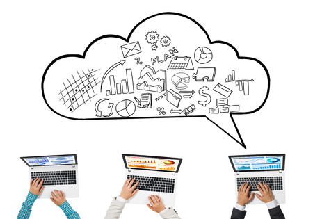 Group of three people with devices in hands working together as symbol of networking and communicationの写真素材