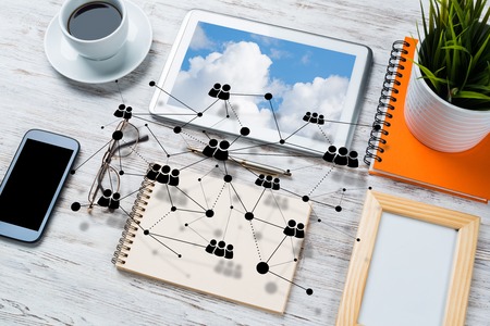 Top view of modern workplace with office stuff and social network connection above presenting still office life. Mixed media.の写真素材