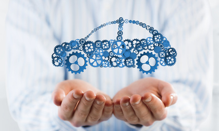 Man presenting in palms concept of car transporation or insuranceの写真素材