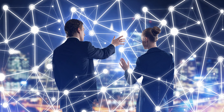 Businessman and businesswoman standing with back and touching connection conceptの写真素材