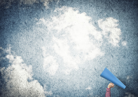 Close of woman making announcement in paper trumpetの写真素材