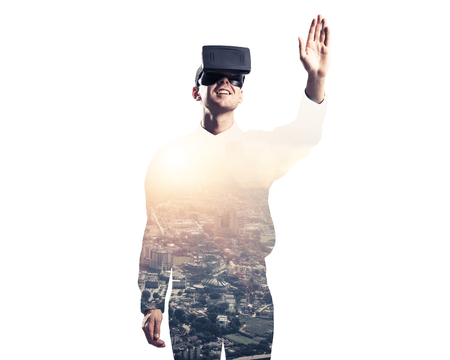 Young man with virtual reality headset or 3d glasses over cityscape backgroundの写真素材