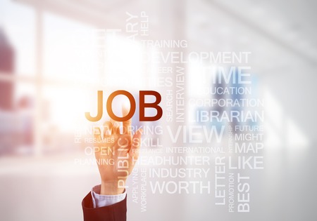 Close of businesswoman hand touching with finger screen with business conceptual wordsの写真素材
