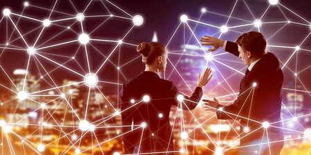 Businessman and businesswoman standing with back and touching connection conceptの写真素材